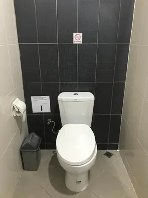 a bathroom with a white toilet in a stall at The Celuk Homestay in Jimbaran