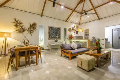 a living room with a couch and a table at Villa Irma in Seminyak
