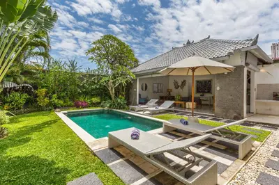 an image of a backyard with a swimming pool and a house at Villa Irma in Seminyak