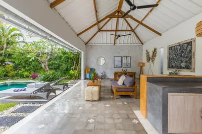 an open living room with a pool and a couch at Villa Irma in Seminyak