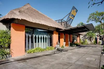 atropical building with a thatched roof at Villa Jerami & Spa in Seminyak