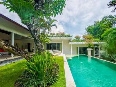 a swimming pool in front of a house at Villa Anema Umalas in Seminyak