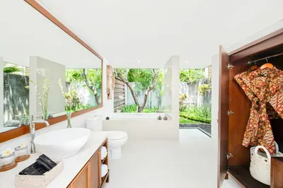 a bathroom with a sink and a toilet and a tub at Mayaloka Villas Seminyak in Seminyak