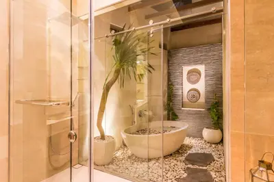a bathroom with a tub with a palm tree in it at Villa Seriska Jimbaran - Spacious 5BR Private Pool Villa with Private Cook, Spa & Tour in Jimbaran