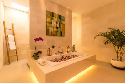 a bathroom with a tub with a plant in it at Villa Seriska Jimbaran - Spacious 5BR Private Pool Villa with Private Cook, Spa & Tour in Jimbaran