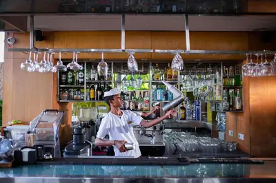 a chef preparing a drink at a bar at THE HAVEN Bali Seminyak in Seminyak