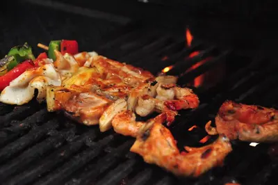 a grill with shrimp and vegetables on it at THE HAVEN Bali Seminyak in Seminyak