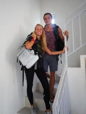 a man and a woman standing on the stairs at Wika Bali Beach House in Jimbaran