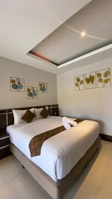 a bedroom with a large bed in a room at The Surya Kuta Villa in Kuta