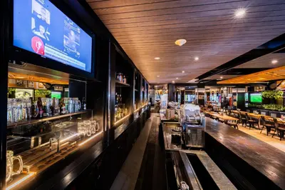 a bar in a restaurant with a large screen at Stark Boutique Hotel and Spa in Kuta