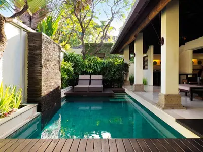 a swimming pool in the backyard of a house at The Amala Boutique Retreat in Seminyak
