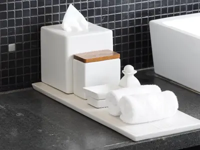 a pile of white towels on a white plate at The Amala Boutique Retreat in Seminyak