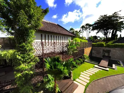 a house with a garden and a fence at The Amala Boutique Retreat in Seminyak