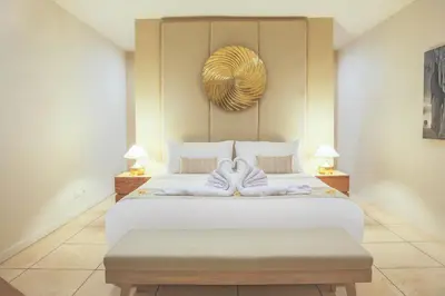 a bedroom with a large white bed with towels on it at Villa La Luvier in Canggu