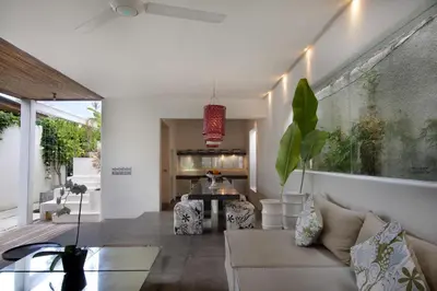 a living room with a couch and a table at Kiss Bali Villas in Seminyak