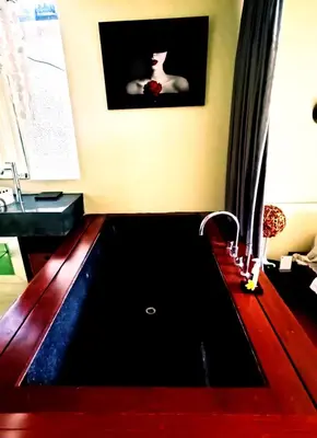 a bath tub in a room with at Kiss Bali Villas in Seminyak