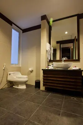 a bathroom with a toilet and a sink and a mirror at Danoya Private Luxury Residences in Seminyak