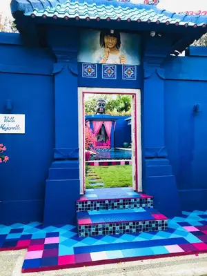 a blue building with a window with a colorful floor at Villa Majorelle Bali in Seminyak