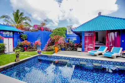 a blue house with a swimming pool in the yard at Villa Majorelle Bali in Seminyak