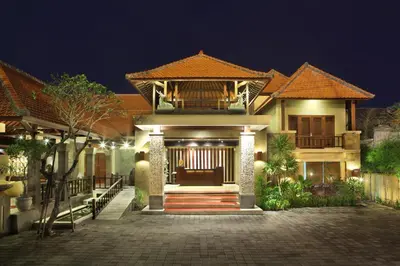a house with a pathway leading to it at night at Adhi Jaya Hotel in Kuta