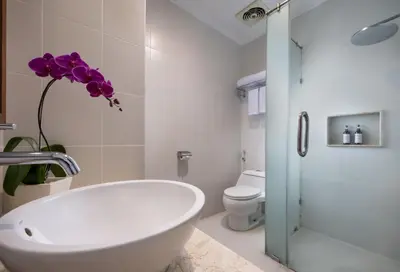a bathroom with a toilet and a sink and a tub at Adhi Jaya Hotel in Kuta