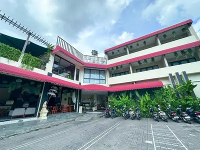 a building with motorcycles parked in front of it at Dekuta in Kuta