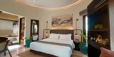 a bedroom with a large white bed in a room at Aruni Bali Jimbaran Boutique Villa in Jimbaran
