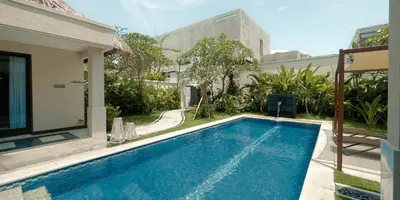 a swimming pool in the backyard of a house at Aruni Bali Jimbaran Boutique Villa in Jimbaran