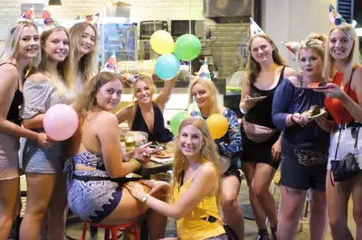 a group of women posing for a picture at a party at Borough Capsule Hostel Bali in Legian
