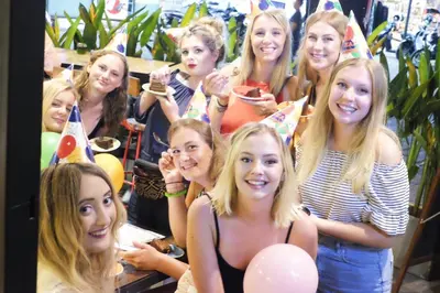 a group of girls posing for a picture at a party at Borough Capsule Hostel Bali in Legian