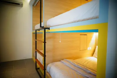 a bedroom with two bunk beds in a room at Borough Capsule Hostel Bali in Legian