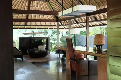 a living room with a table and a fireplace at Kayumanis Jimbaran Private Villas & Spa in Jimbaran