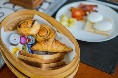 a basket of bread and pastries on a table at Ziva a Boutique Villa in Seminyak