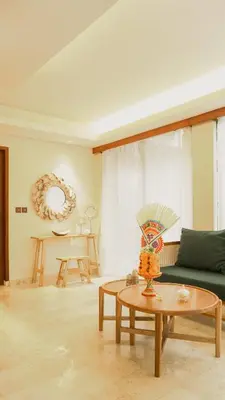 a living room with a green couch and a table at Annora Villas Seminyak in Seminyak
