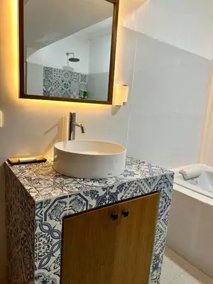 a bathroom with a sink and a mirror on a counter at The Taman Ayu Seminyak 10 Minute walking to the BEACH in Seminyak