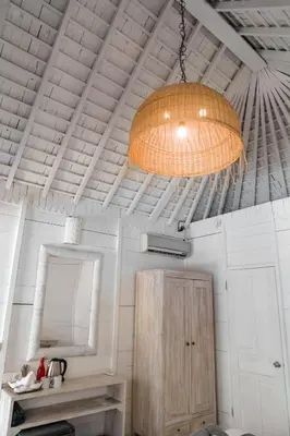 a large light hanging from the ceiling of a bathroom at Easy Surf Camp in Kuta
