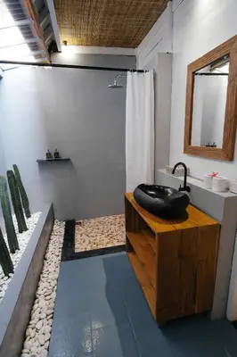 a bathroom with a black sink on a wooden table at Easy Surf Camp in Kuta