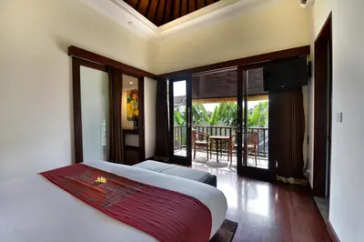 a bedroom with a bed and a balcony at The Khayangan Dreams Villa, Seminyak in Seminyak