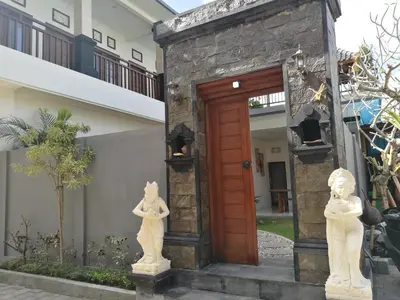 a door to a house with statues in front of it at Dikubu Belong Seminyak in Seminyak