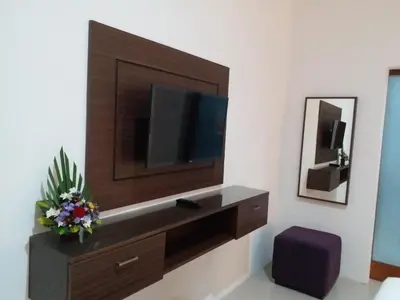 a living room with a tv on a wall at Dikubu Belong Seminyak in Seminyak