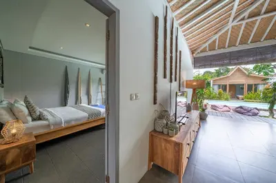 a living room with a couch and a bed at Villa Nahema - 4BR Villa in Seminyak Next to the Beach in Canggu