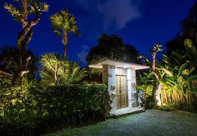 a small house with a door at night at Rachline Villa in Kerobokan
