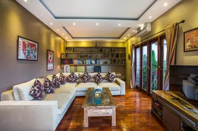 a living room with a couch and a table at Rachline Villa in Kerobokan