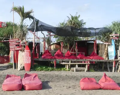 a group of red bags sitting on the beach at Villa Kobe Beachside Berawa Canggu location in Canggu
