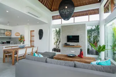a living room with a couch and a table at Villa Kobe Beachside Berawa Canggu location in Canggu