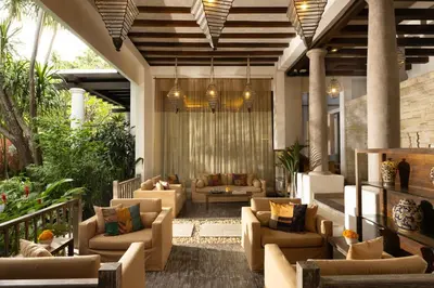 an outdoor living room with couches and chairs at Alaya Dedaun Kuta in Legian