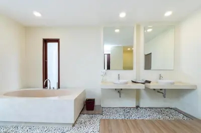 a bathroom with two sinks and a large tub at Jay's Villa Umalas in Canggu