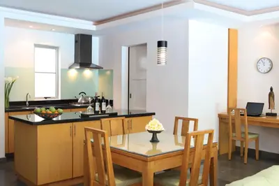 a kitchen and dining room with a table and chairs at Bali Island Villas and Spa Seminyak in Seminyak
