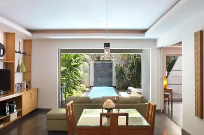 a living room with a couch and a table at Bali Island Villas and Spa Seminyak in Seminyak