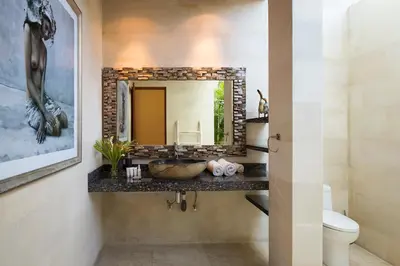 a bathroom with a sink and a mirror at Dream villa Seminyak in Seminyak
